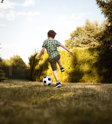 Boy Playing Football - Learn about Myopia Causes now