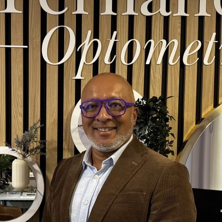 Gerard Fernandes standing inside our Gloucester Road practice wearing stylish Mykita frames.