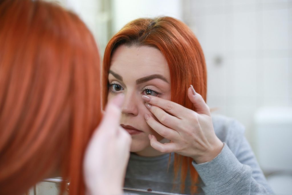 A woman putting in some contact lenses.